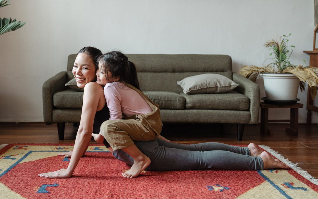 mom and daughter playing on carpet